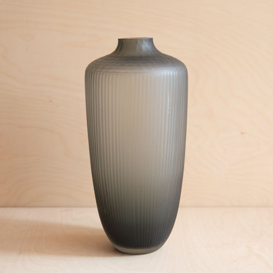 Gray ribbed vase on a beige background
