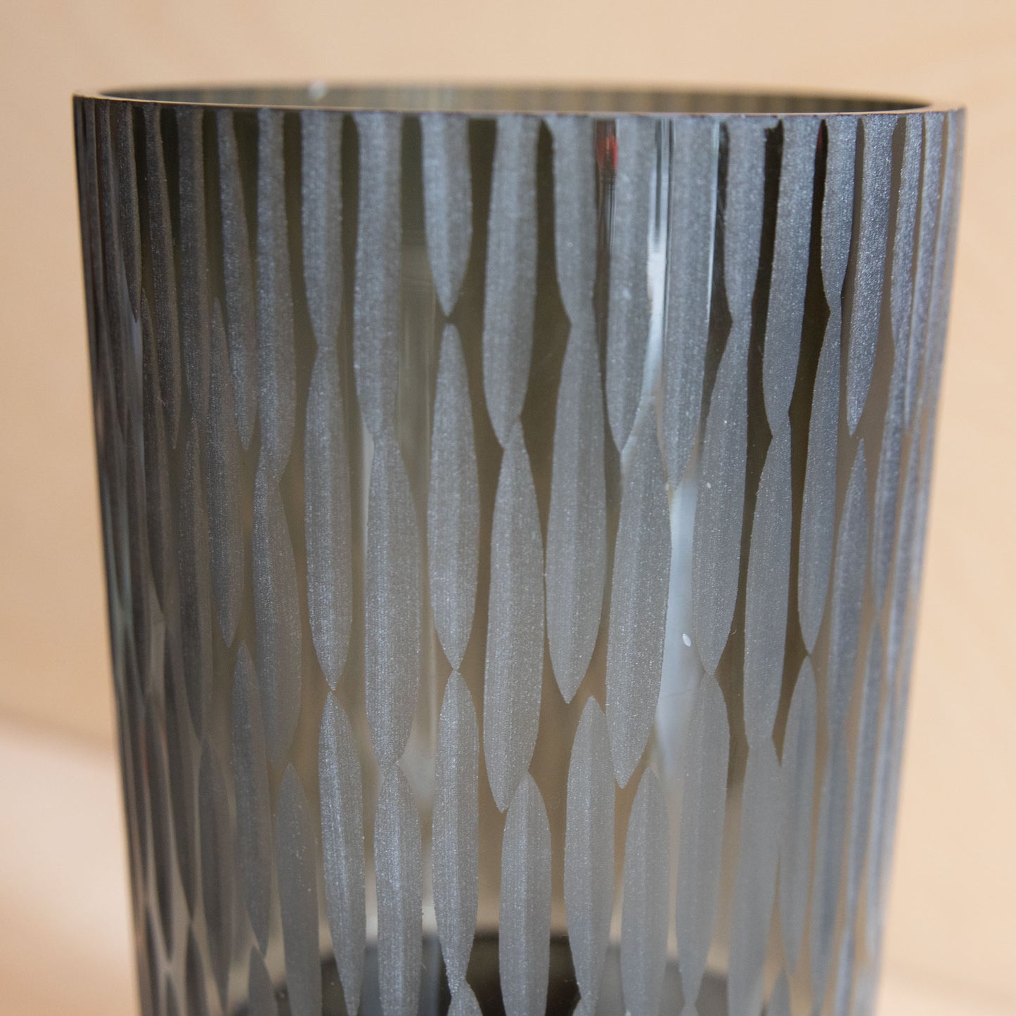 Decorative vase with a textured pattern on a beige background