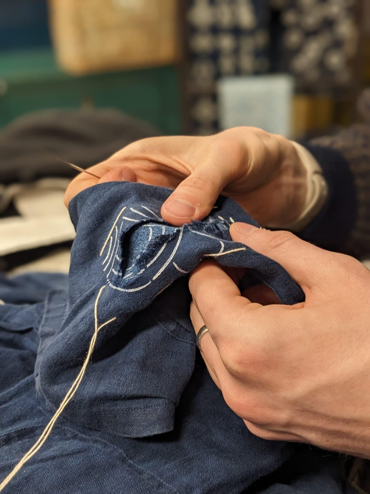 Visible mending workshop at Rouge in London using a darning mushroom and a sashiko stencil
