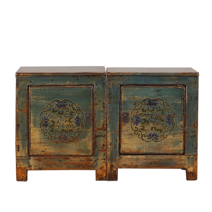 Pair of vintage wooden cabinets with floral carvings on a white background