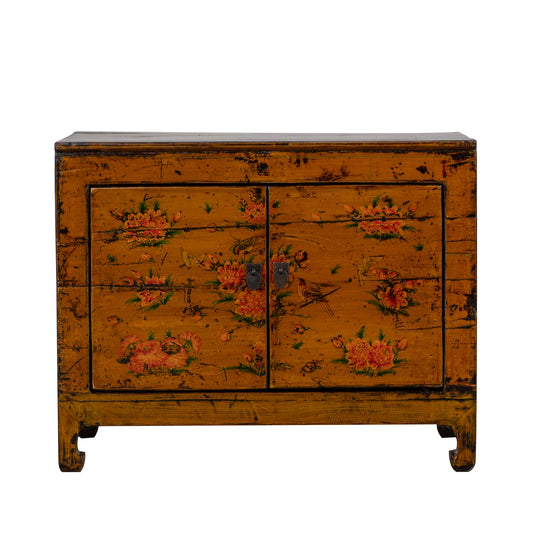 Vintage orange wooden cabinet with floral patterns on a white background