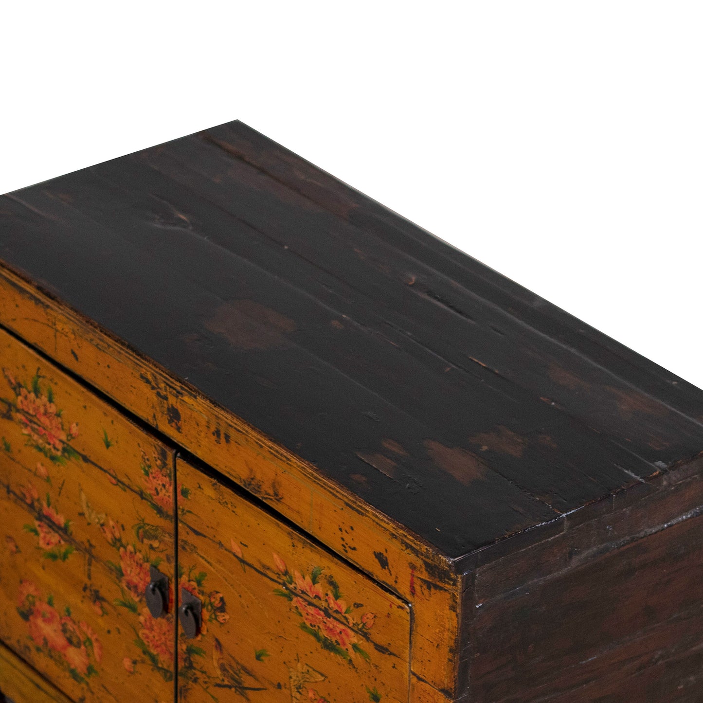 Vintage orange wooden cabinet with floral designs on a white background