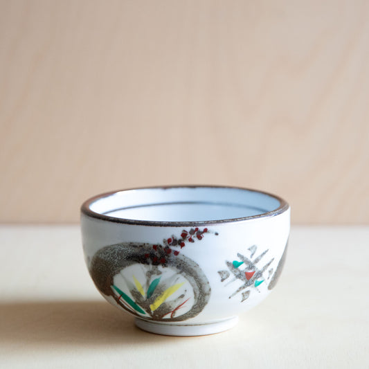 Ceramic bowl with artistic design on a beige background