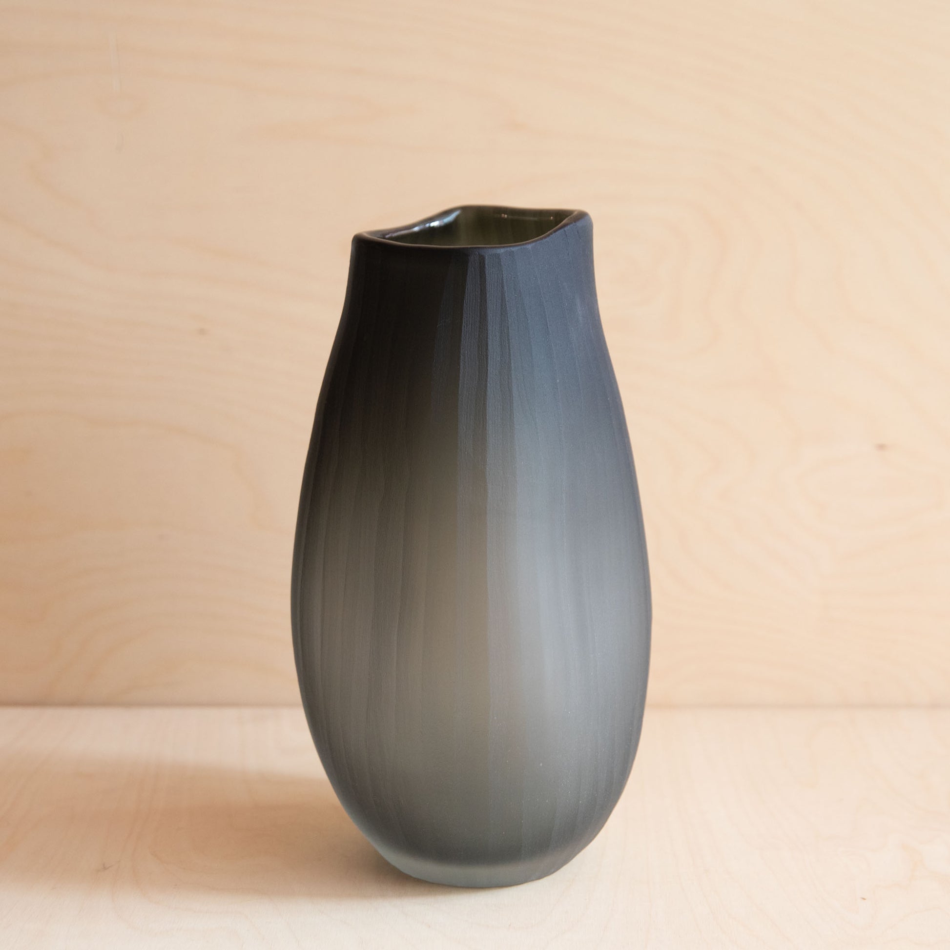 Gray glass vase on a beige background