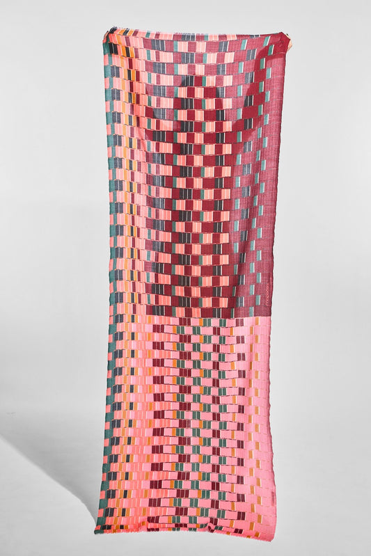 A rectangular woven textile with a geometric basketweave pattern in pink, coral, teal, and burgundy, displayed vertically against a light gray background.